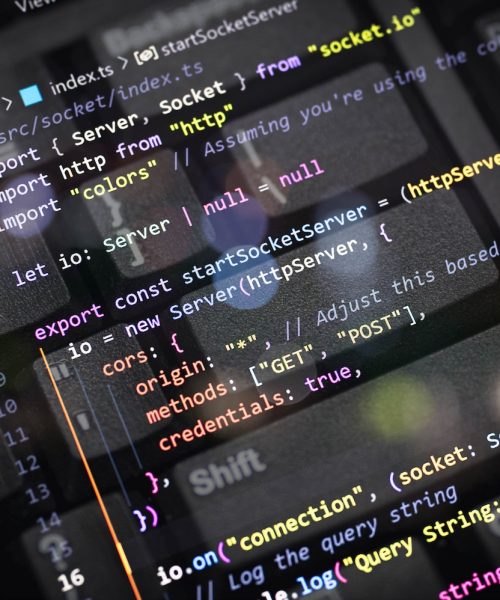 Close-up of colorful TypeScript code for server and socket connection overlayed on a computer keyboard. Perfect for web developers, programmers, tech blogs, coding, and software development content.