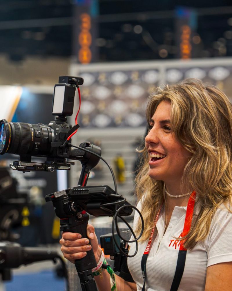 Shelby Mills M2 Videographer at a trade show smiling