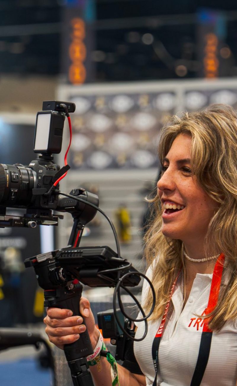 Shelby Mills M2 Videographer at a trade show smiling
